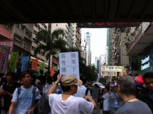 This man holding a placard saying "Down with wolf Leung - Real Universal Suffrage Wanted"