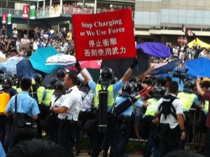 The police held up a warning banner to stop people from joining those already at the Government Headquarters protest site